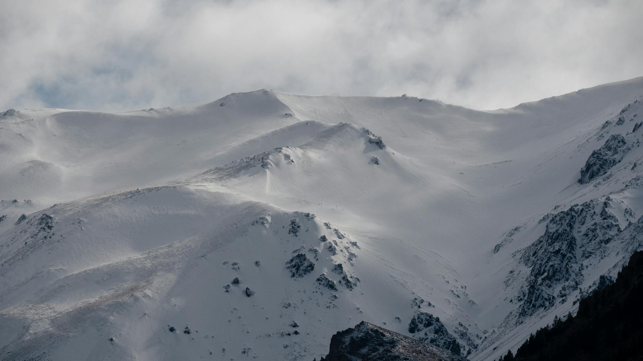 Breathtaking view of snow-covered mountains in Esquel, Argentina, showcasing winter's beauty.
